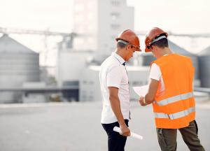 engineers-in-helmets-standing-by-the-factory.jpg