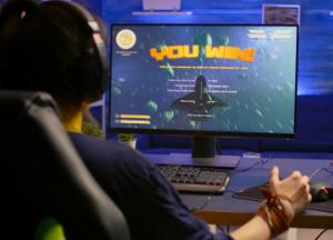 excited-pro-gamer-with-professional-headphones-making-winner-gesture-while-playing-space-shooter-video-games_0.jpg
